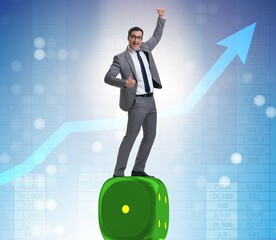 Businessman balancing on top of dice stack in uncertainty concep