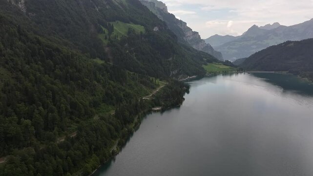 Kl&ouml;ntalersee, Vordergl&auml;rnisch, Glarus, Switzerland - A Scenic View of a Lake Encircled by Lush, Green Mountainous Terrain - Aerial Drone Shot