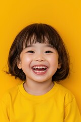 A Happy Chinese Girl Against A Yellow Background