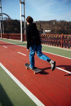 A skateboarder goes, pushes off on a skate.