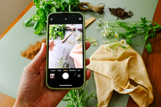 View of phone talking picture of herbs and spice on table