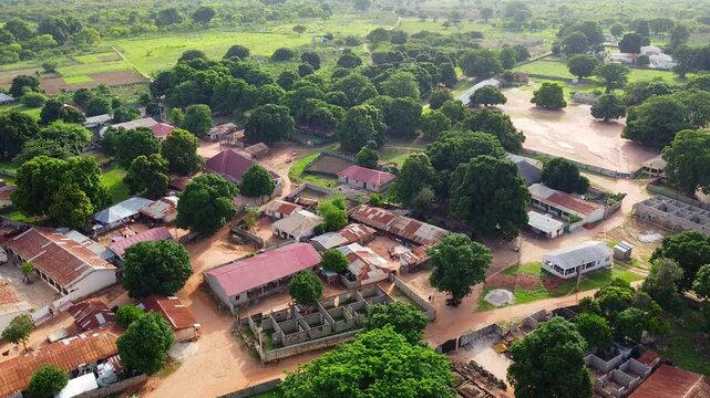 Aerial view of typical African Village with red roofs, trees and vegetation. Nuimi Lameng, Gambia