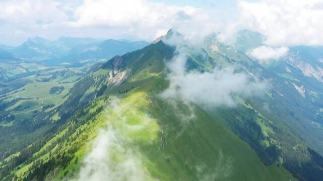 Aerial shot of clouds hanging over the hardergrat trail in the Swiss alps
