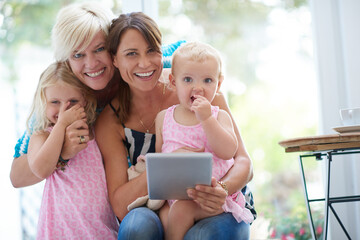 Portrait, lesbian parents and tablet for children, adoption and happy with family home, bonding or...