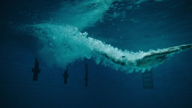 Man diving and swimming in the pool