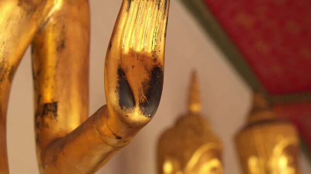 Close up of Buddha hand with faded golden color on palm, Wat Pho temple