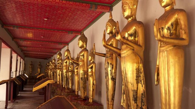 Collection of golden color statues at Wat Pho temple in Bangkok, Thailand