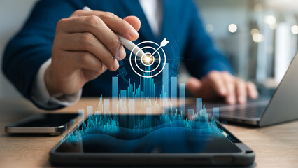 Business goal success concept, businessman touch symbol of digital marketing and target of leadership, unlock your goals with strategy, planning and goals. Suitable for business concept.