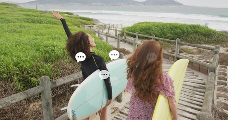 Speech bubbles animation over two women walking with surfboards towards beach