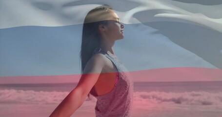 Woman enjoying beach with arms outstretched over waving russian flag animation - Powered by Adobe