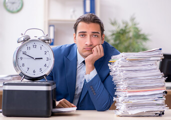 Young male employee making copies at copying machine
