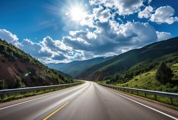Fototapeta premium Winding Road Through Mountainous Landscape Under a Sunny Sky