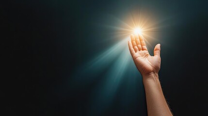A hand reaching out towards a bright light, symbolizing hope, guidance, and connection in a dark environment.
