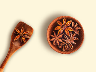 Star Anise in wooden bowl with spoon isolated on white background , top view , flat lay.