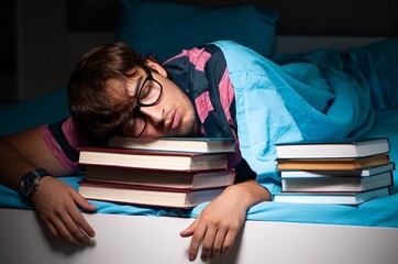 Young student preparing for exams at night at home