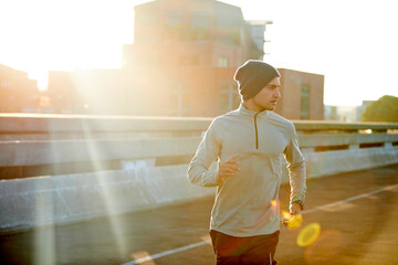 Man, runner and sunrise in road, training and outdoor for fitness, exercise and health in morning....