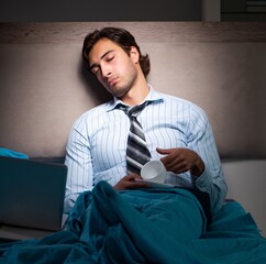 Tired businessman working overtime at home at night