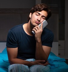 Man watching tv at night in bed