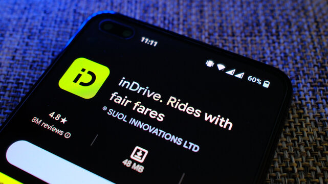 inDrive taxi service app in play store page on mobile phone display. London, UK, 08.24.2024