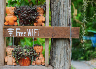 The free Wi-Fi sign is made from a brown wooden board.