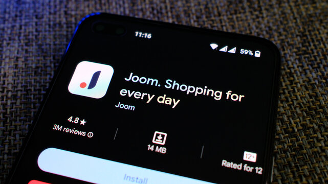 Joom online shopping app in play store page on mobile phone display. London, UK, 08.24.2024