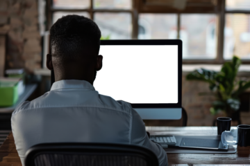 Unrecognizable black businessman using computer with empty blank screen