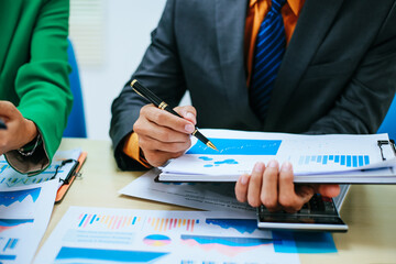 A group of professional business men and women are having a constructive meeting, discussing...