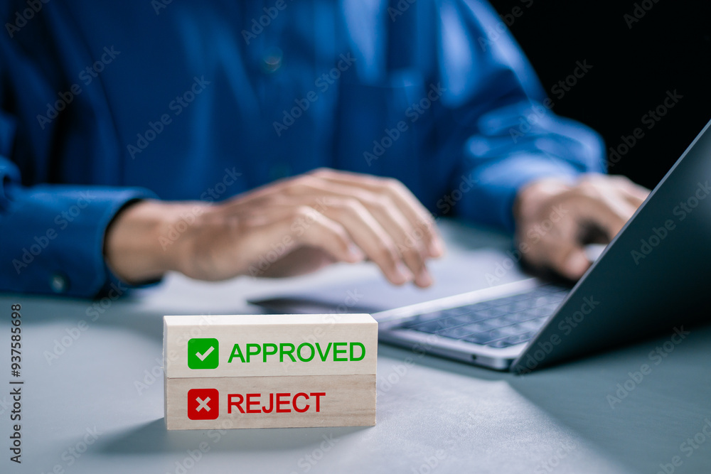 Poster option to approve or reject on wooden blocks with businessman working in background. document approv