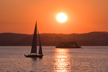 Bodensee, Segelboot und Autof&auml;hre im Sonnenuntergang