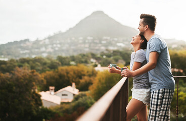 Balcony, couple and love in morning with coffee, expresso and warm beverage on vacation in Denmark. Outside, man and happy woman with laugh on honeymoon, marriage and bonding with hug by space