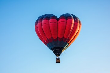 Naklejka premium Red and black hot air balloon soaring through blue sky