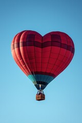 Fototapeta premium Red heart shaped hot air balloon flying in the sky