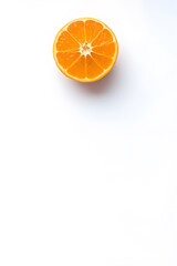 Fototapeta premium A single orange fruit on a white background, showcasing its vibrant color and texture.