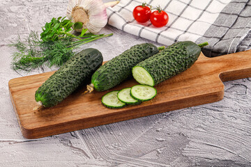 Raw green cucumbers with slices