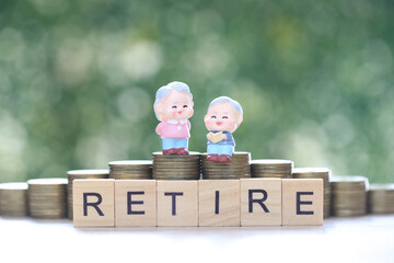 Mutual fund,Love couple senior and stack of coins money on natural green background, Save money for...