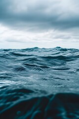 Fototapeta premium Macro shot of the rippling ocean surface under an overcast sky AI generated illustration