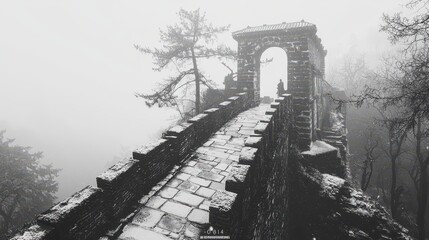 Fototapeta premium Snowy Pathway on the Great Wall of China in Foggy Landscape