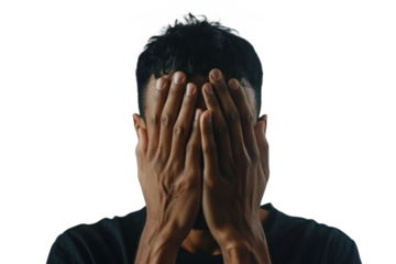 Man with his face partially obscured by his hands, showing a moment of overwhelm, on a white backdrop.