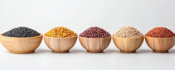 A vibrant assortment of colorful legumes displayed in wooden bowls, showcasing various types of beans and lentils on a neutral background.