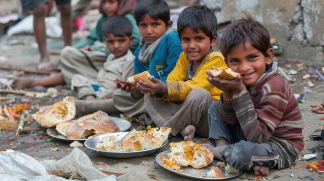 Happy Indian children enjoy food and bread on dirty crowded streets. Social problem of poverty, hunger, and lack of clean, drinking water.