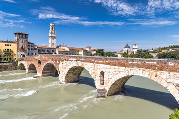 The Ponte Pietra roman arch bridge crossing the Adige River in Verona town, Italy, Europe.