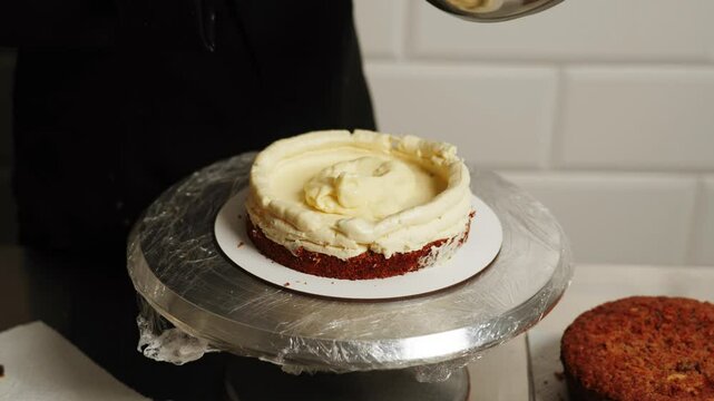The process of assembling a carrot cake. The confectioner puts the cake on the cake and adds the ingredients. The concept of confectionery products