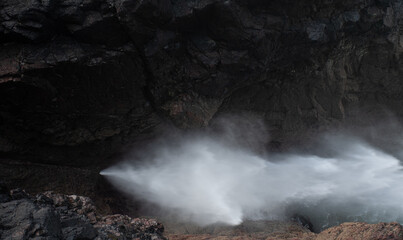 Water emerging from the blowhole 'The Devil's Bellows' Kynance Cove Cornwall