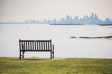 bench in the park with background Melbourne city