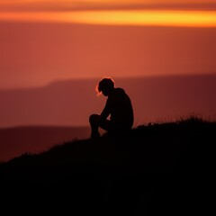 Silhouette of Person on Mountain Peak Watching Nature at Sunset