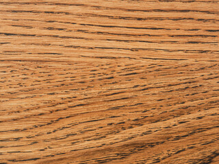 Close-up of a wooden surface with distinct texture. Natural patterns and warm wood tones create an attractive backdrop for a variety of design