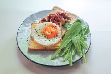 bread with egg and cheese topping or  sunny side up egg , lettuce and almond with dried cranberry