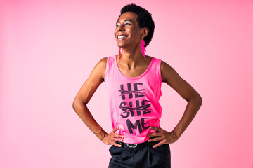 Fashionable fluid gender man wearing non binary clothing posing in studio - Hispanic black male...