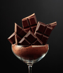 Broken black chocolate bar.