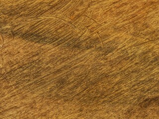 Textured hardwood surface, brownish yellow background